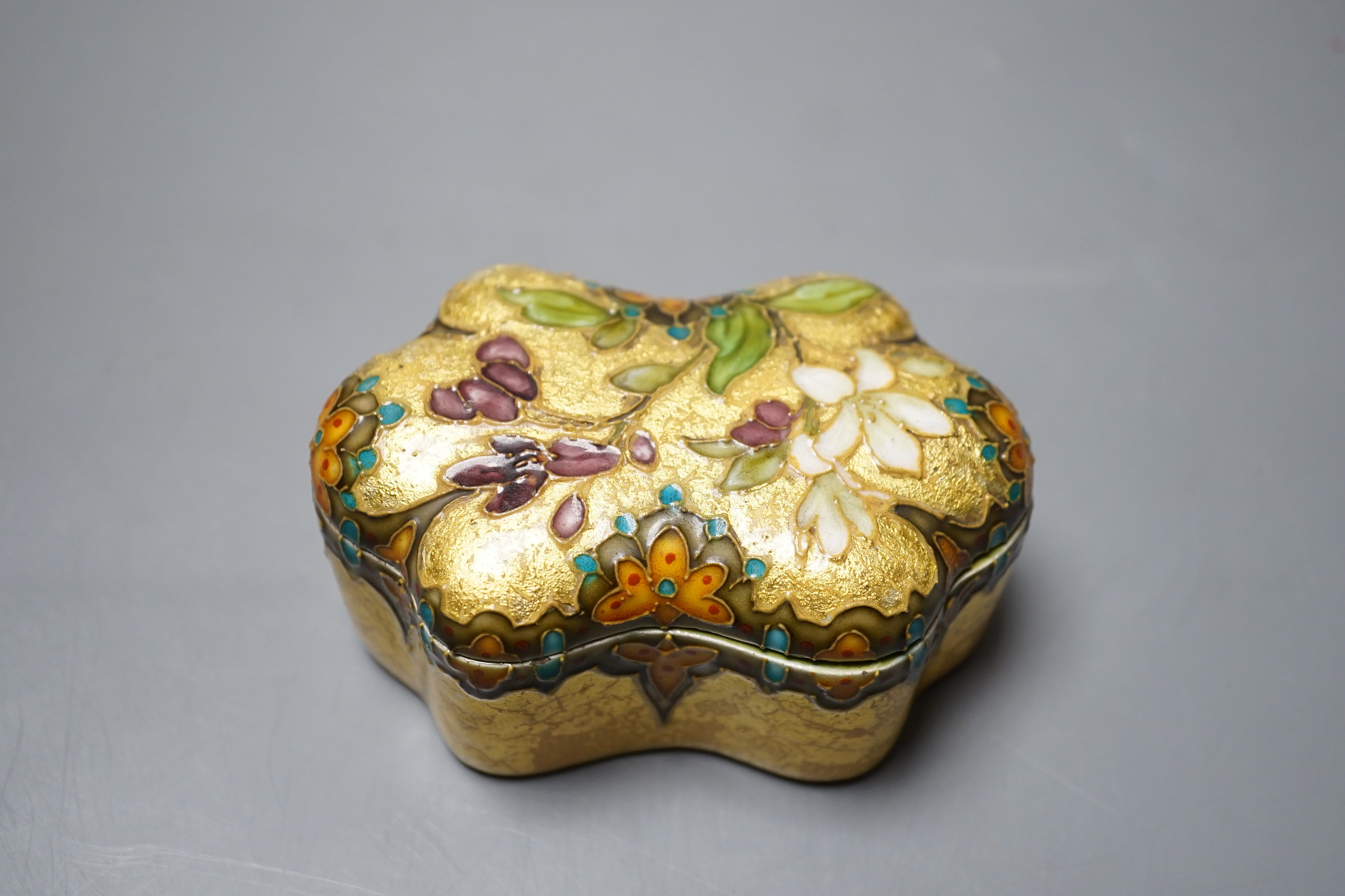 A Clement Massier, Golfe Juan box with enamelled floral decoration on ground yellow base, 9.5cm, original paper labels